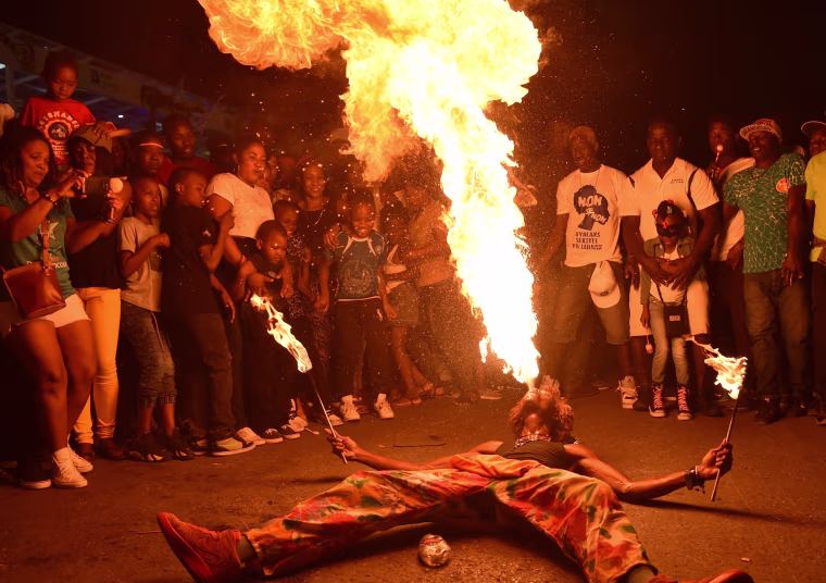 Image: A fire-swallower performs during the 2018 National Carnival Parade