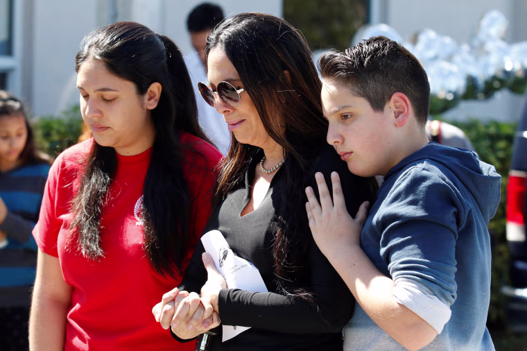 Students and parents from Marjory Stoneman Douglas High School attend a memorial.