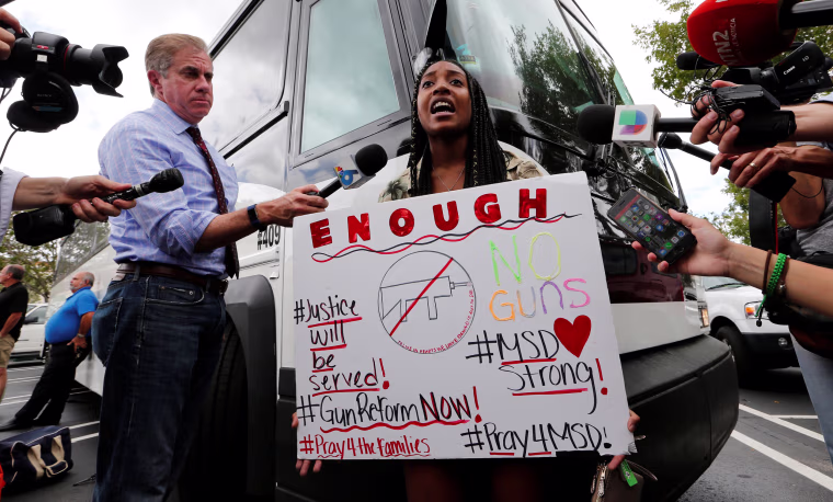 Image: Tyra Hemans, 19, a senior at Marjory Stoneman Douglas High School, speaks before boarding busses with other students to travel to Tallahassee, Florida, to meet with legislators, in Coral Springs
