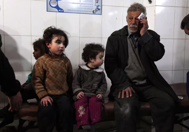 Wounded Syrians wait to receive treatment in Kafr Batna on Feb. 21.