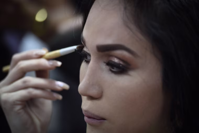 Image: Cristobal Altuzar of Mexico puts on makeup before the final round of the Miss International Queen 2018 transgender beauty pageant