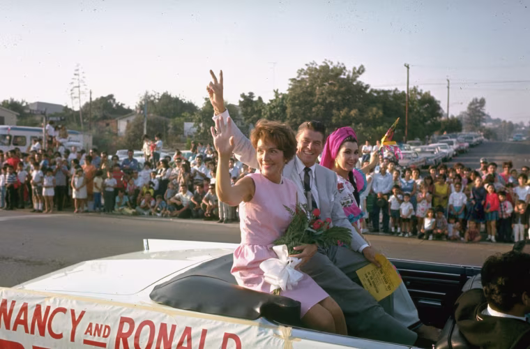 Image: California Republican gubernatorial candidate Ronald Reagan and his wife Nancy wave to spectators