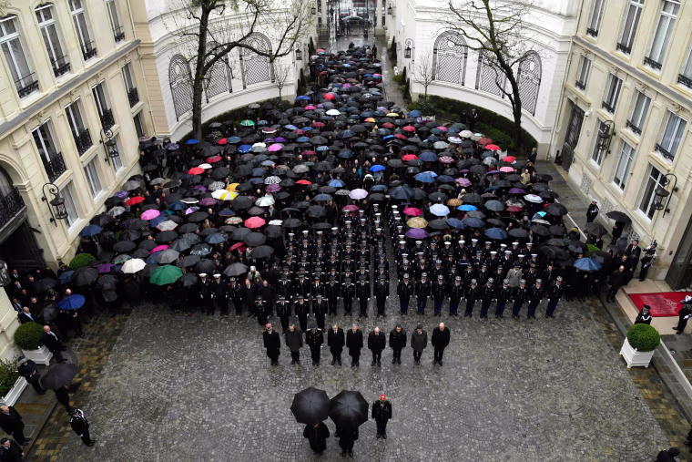 Image: Officials hold a minute of silence