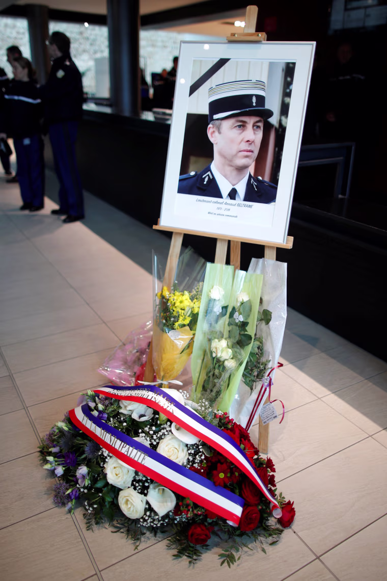 Image: A portrait of late officer Colonel Arnaud Beltrame is seen at the Gendarmerie Nationale Headquarters in Issy-les-Moulineaux