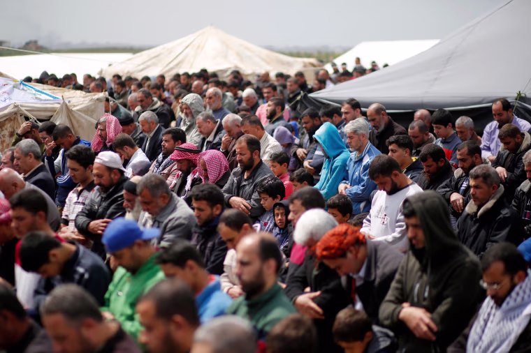 Palestinians pray on the Gaza border with Israel, east of Jabalia, on March 30.