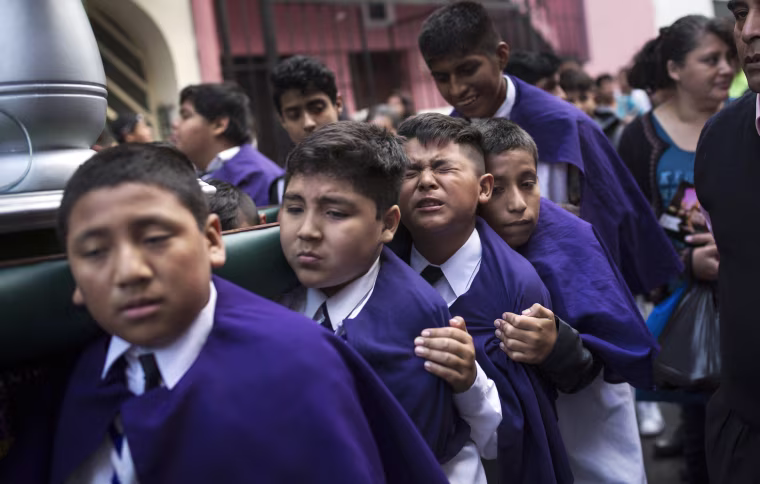 Children carry the image of Jesus Christ while taking part in a Holy Week procession in Lima, Peru, on April 1. Traditionally, processions take place throughout Peru during the Easter Holy Week.