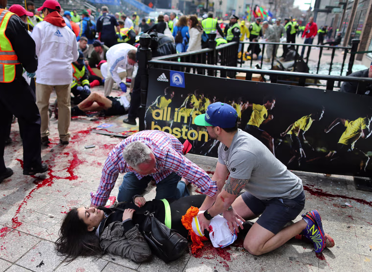 Image: Bystanders help an injured woman