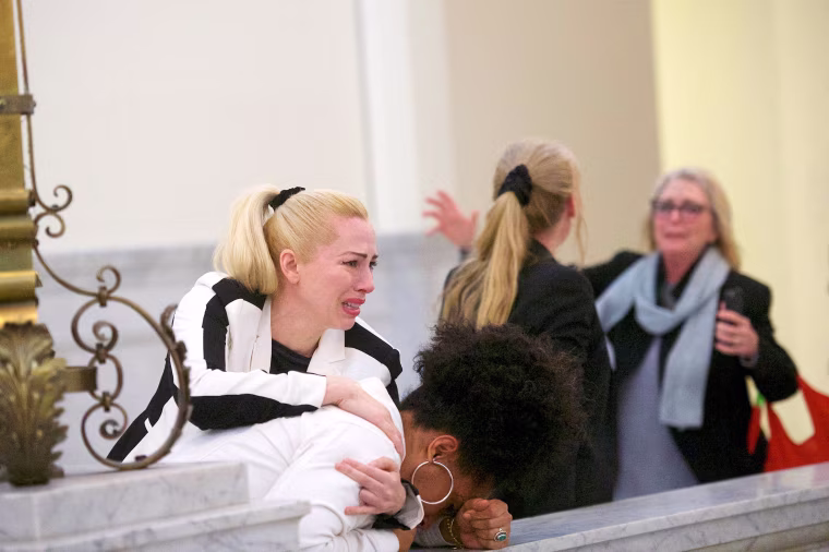 Image: Bill Cosby accusers Caroline Heldman, Lili Bernard and Victoria Valentino (R) react after the guilty on all counts verdict was delivered in the sexual assault retrial at the Montgomery County Courthouse in Norristown