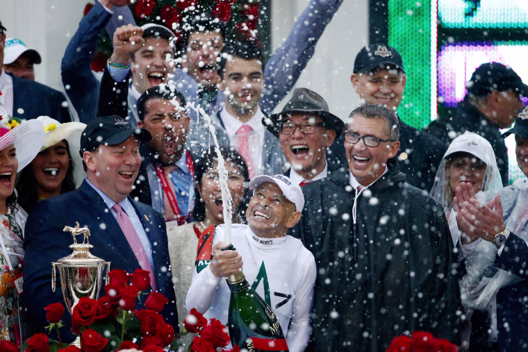Image: Jockey Mike Smith celebrates after winning the 144th running of the Kentucky Derby