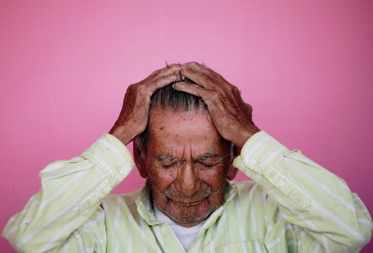 Image: Manuel Garcia, who says he is 121-years old, fixes his hair before posing for a photograph, outside his home in Ciudad Juarez