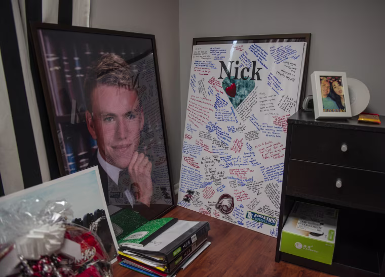 Image: A picture and a signed poster from his memorial sit in the room of Nick Dworet at his home in Coral Springs