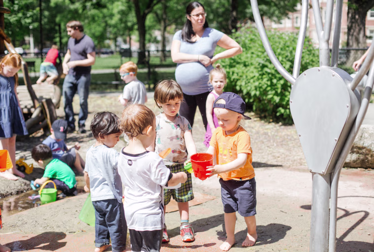 Image: Zyler, 3, center, plays in a park in Cambridge