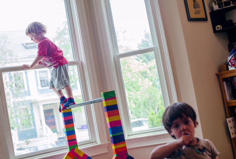 Image: Kadyn and Zyler Sharpe,3, play at home in Cambridge