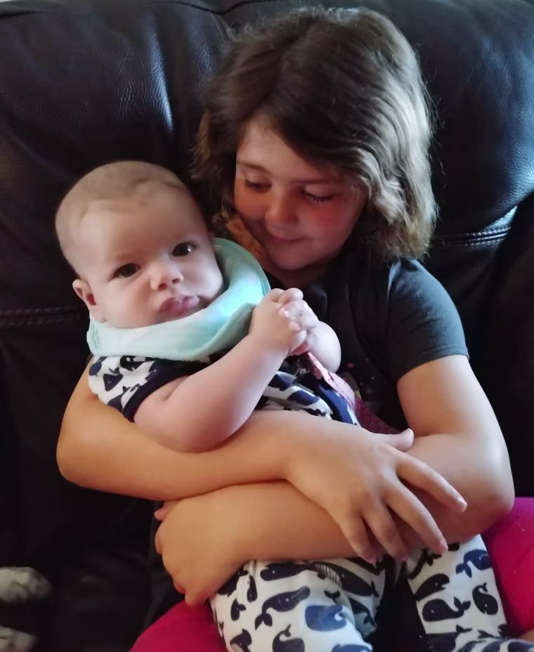 Hazel Dennis, 7, holds 5-month-old Sparrow