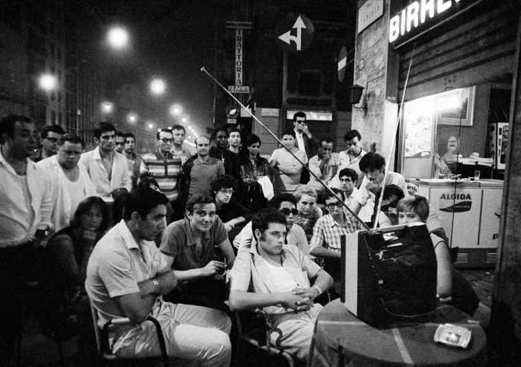 Italians watch the moon landing at a sidewalk cafe in the center of Milan.
