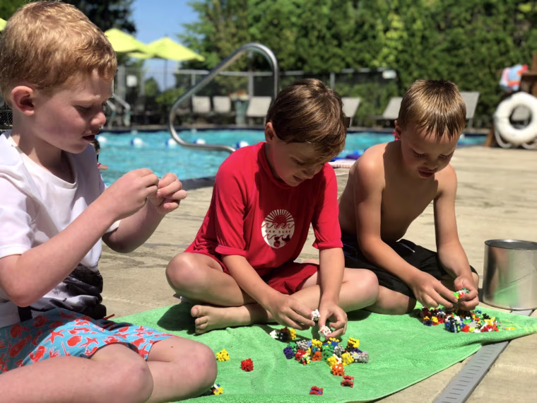 Plus-Plus toys kept second-grade friends Aiden, Christopher and Will entertained--without screens--while their siblings were in swim lessons.