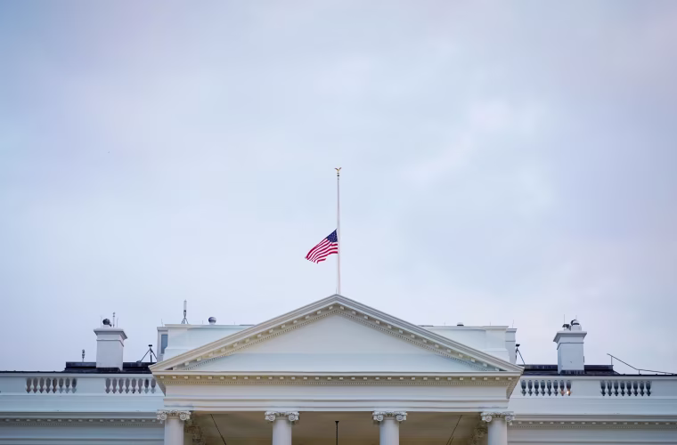 Image: A flag flies at half-staff above the White House