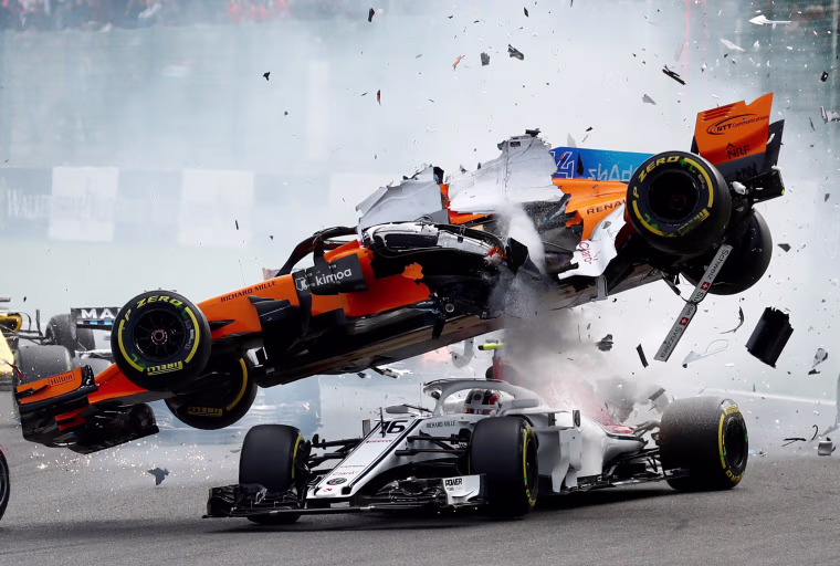 Image: Fernando Alonso's McLaren flies through the air and lands on top of Charles Leclerc's Sauber