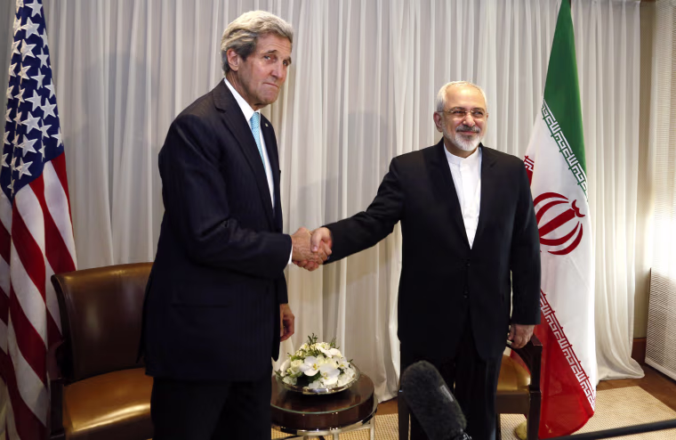 Image: U.S. Secretary of State John Kerry shakes hands with Iranian Foreign Minister Mohammad Javad Zarif before a meeting in Geneva