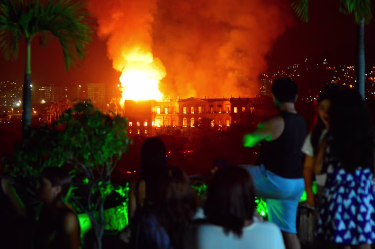 Image: People watch as a massive fire engulfs the National Museum in Rio de Janeiro
