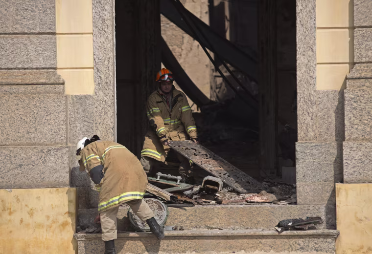 Image: Firefighters remove charred debris from Brazil's National Museum