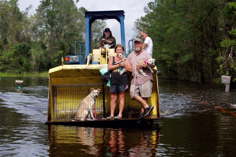 Image: A resident transports evacuees and their pets in the bucket of his tractor as the Northeast Cape Fear River breaks its banks during flooding after Hurricane Florence in Burgaw, North Carolina