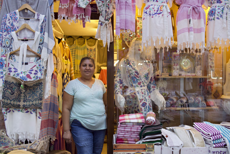 Image: Pembe Cavdar waits for customers at her Bursa clothing store