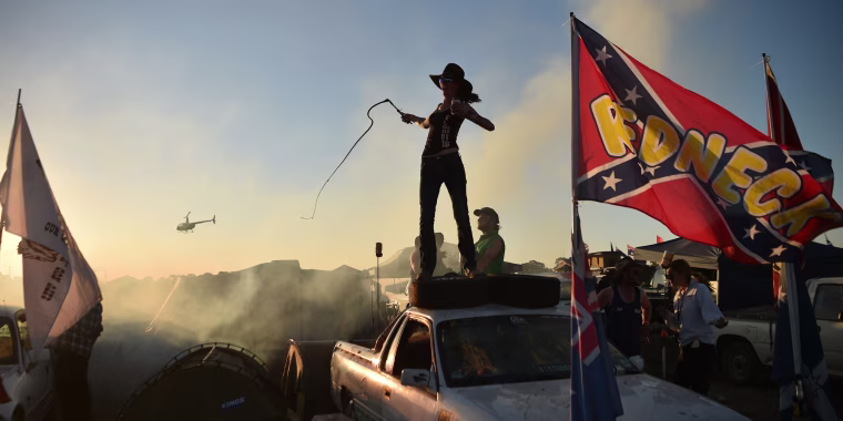 A woman cracks a bull whip on top of her truck at the annual Deni Ute Muster in Deniliquin, Australia, on Sept. 29.