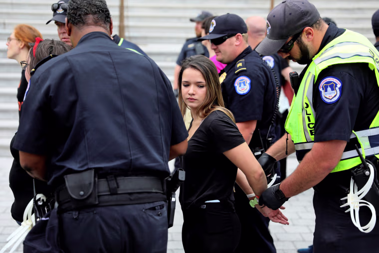 Image: U.S. Capitol Police arrest protesters in the hours ahead of a scheduled U.S. Senate vote on the confirmation of Supreme Court nominee Kavanaugh in Washington