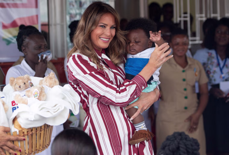 Image: First lady Melania Trump holds a baby in Accra, Ghana