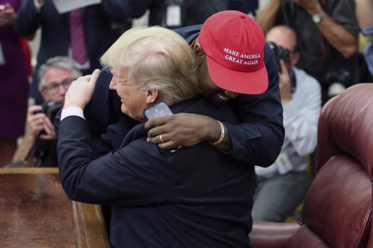 President Donald Trump hugs rapper Kanye West during a meeting in the Oval office on Oct. 11, 2018.