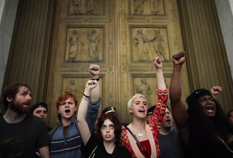 After overrunning police barricades, protesters chant as they block the doors to the U.S. Supreme Court while demonstrating against the confirmation of Associate Justice Brett Kavanaugh on Oct. 6, 2018. The protesters marched up to the doors of the court as Kavanaugh was inside taking his oath.