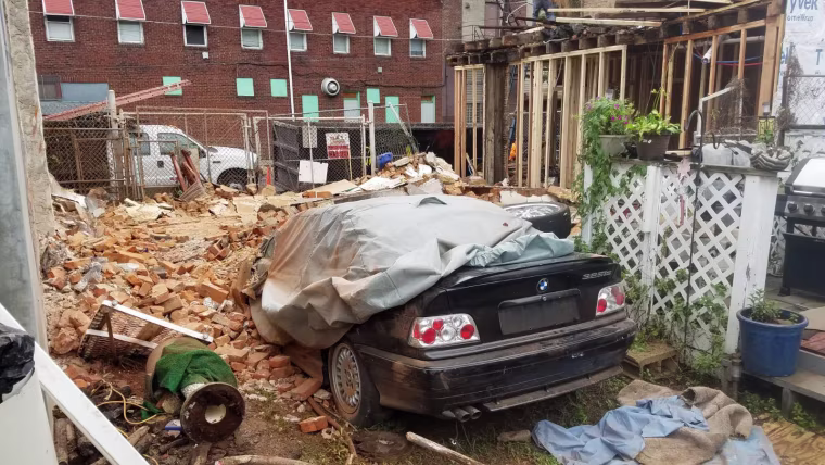 Magic was trapped in this rubble after the three-story brick wall from a neighboring home fell into Jose Gonzalez's yard.