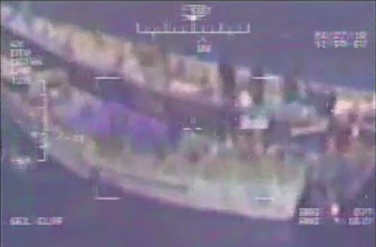 Packages are transferred from a dhow to a skiff in the Gulf of Aden on Aug. 27, 2018.