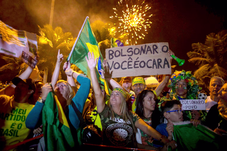 Image: Supporters of far-right presidential candidate Jair Bolsonaro, celebrate in front of his house in Rio de Janeiro, after he won Brazil's presidential election, on Oct. 28, 2018