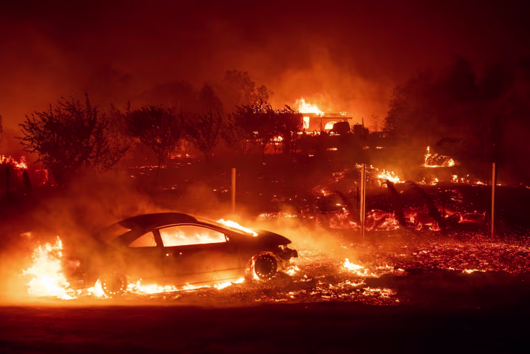 Vehicles and homes burn as the Camp fire blazes through Paradise, California