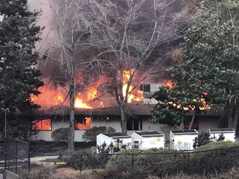 The back of Adventist Health Feather River Hospital in Paradise, California, burns as it is overtaken by the Camp Fire.