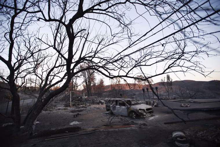 Image: The burnt wreckage of a vehicle and debris are seen in the aftermath of the Woolsey fire in Malibu, Southern California