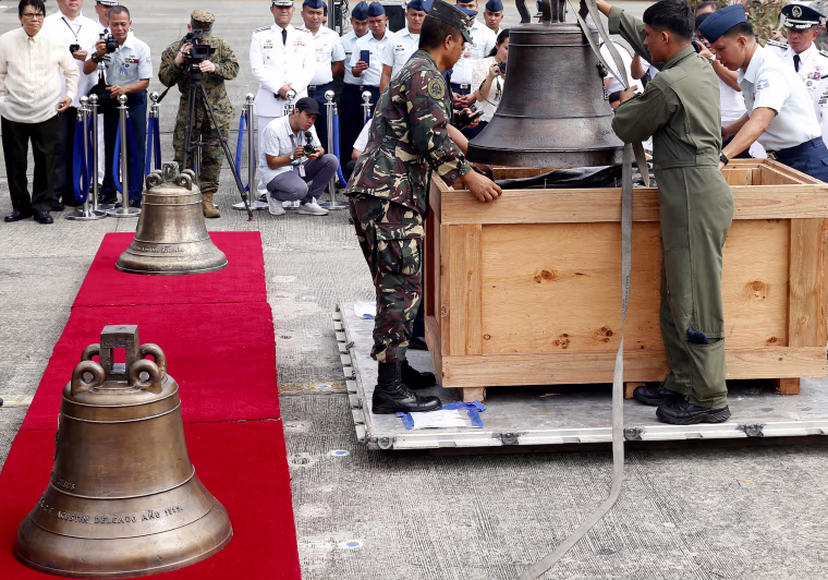 Image: Philippine military personnel unload the three church bells