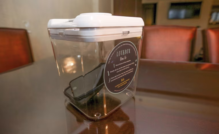 Image: A locked box holding cell phones during a digital detox visit to the Wyndham Grand Hotel in Chicago