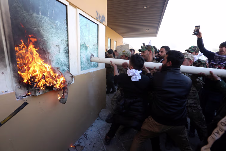 Image: Diplomatic staff evacuated as mob storms U.S. Embassy compound in Baghdad