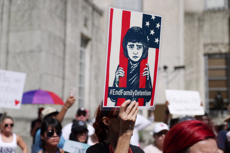 Demonstrators protest the Trump administration's immigration policies during a "Families Belong Together" rally in Houston