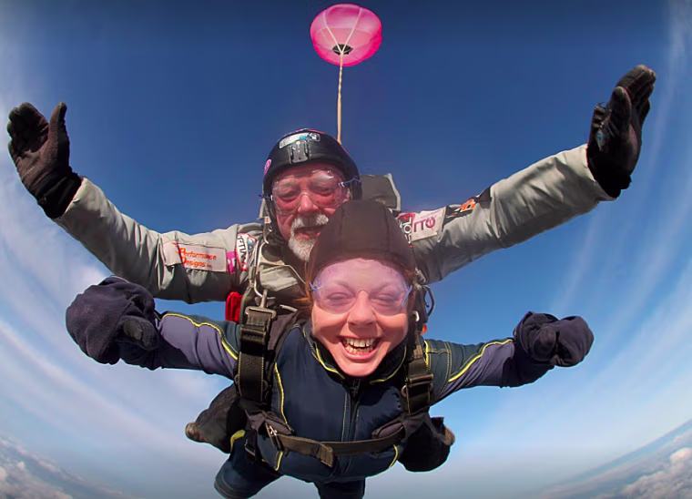 Marianne Power jumping out of an airplane.