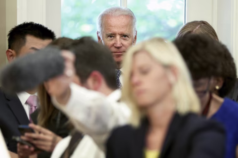 Image: U.S. Vice President Biden stands behind reporters as President Obama and U.N. Secretary-General Ban make statements after their meeting in the Oval Office at the White House in Washington