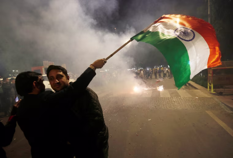 Image: A man holds an Indian flag in New Delhi