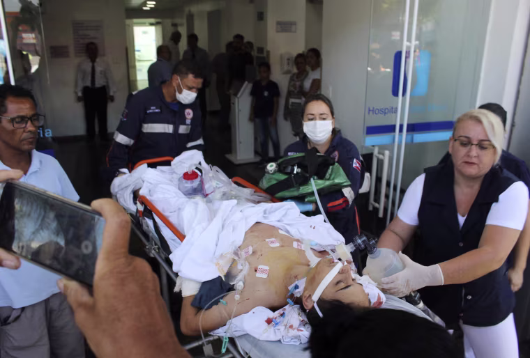 Image: A teenager who was injured during a shooting at the Raul Brasil State School is carried on a gurney into a hospital in Suzano, Brazil, on March 13, 2019.