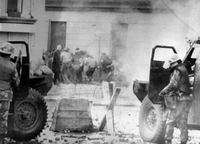 Image: British soldiers take cover while dispersing protesters with tear gas in Londonderry on Jan. 30, 1972
