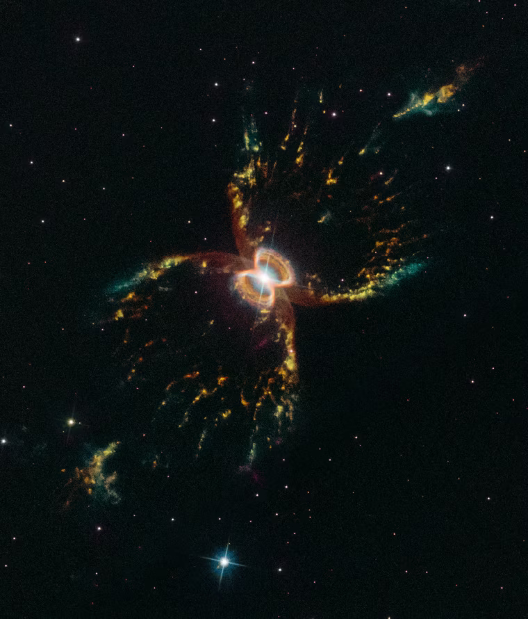In celebration of the 29th anniversary of the launch of NASA's Hubble Space Telescope, astronomers captured this festive, colorful look at the tentacled Southern Crab Nebula. The nebula, officially known as Hen 2-104, is located several thousand light-years from Earth in the southern hemisphere constellation of Centaurus. It appears to have two nested hourglass-shaped structures that were sculpted by a whirling pair of stars in a binary system. The duo consists of an aging red giant star and a burned-out star, a white dwarf. The red giant is shedding its outer layers. Some of this ejected material is attracted by the gravity of the companion white dwarf.