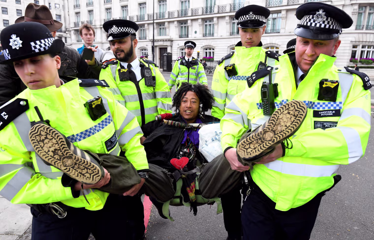 Image: Members of the police carry a demonstrator during the Extinction Rebellion protest at the Marble Arch in London