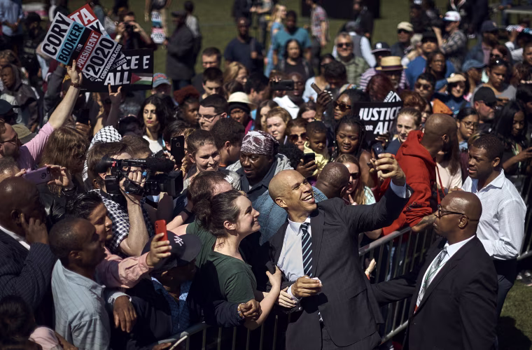 Image: Sen. Cory Booker, D-NJ, takes a selfie with supporters during his campaign kickoff event in Newark on April 13, 2019.